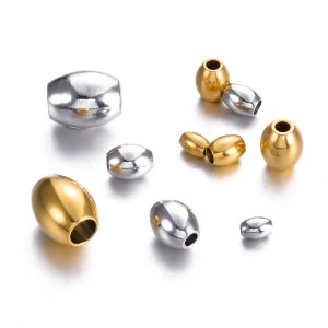 May include: Assortment of oval-shaped metal beads in gold and silver finishes. The beads have a smooth, polished surface and are ideal for jewellery making.