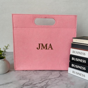 May include: A set of three ceramic mugs with a speckled, matte finish. The mugs are in shades of cream, light gray, and dark gray. Each mug has a simple, modern design and a rounded handle.