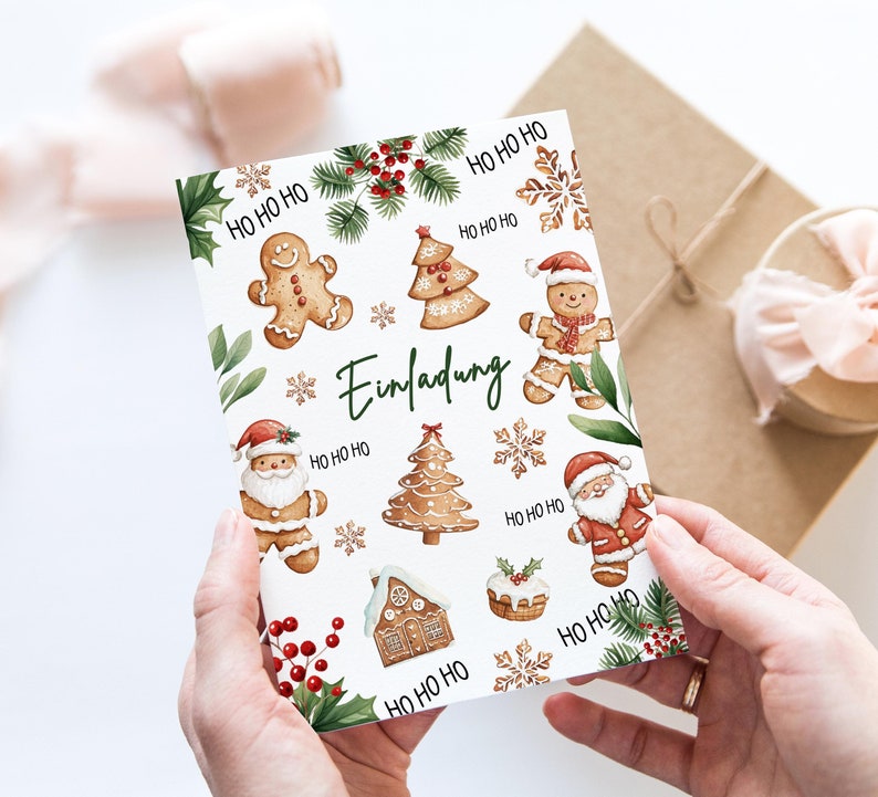 May include: A white card with a Christmas invitation design. The card features gingerbread men, gingerbread houses, Christmas trees, and Santa Claus. The text on the card reads "Einladung" which is German for "Invitation".