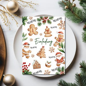 May include: A white card with a Christmas theme featuring gingerbread cookies, a gingerbread house, and the text "Einladung" (German for "Invitation"). The card is decorated with red berries, snowflakes, and green leaves.