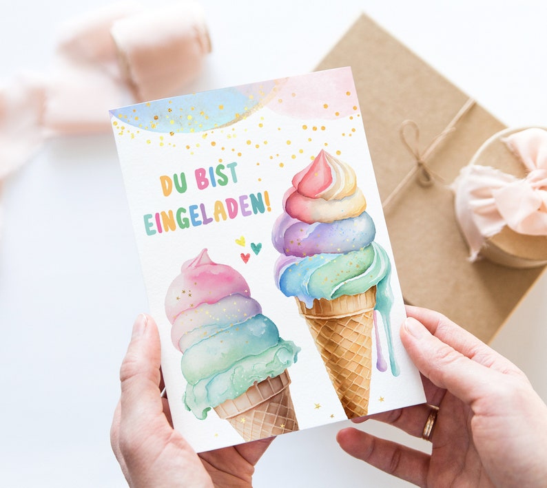 May include: A greeting card featuring watercolor illustrations of two ice cream cones with pastel-colored scoops. The text "DU BIST EINGELADEN!" is written in colorful letters. Gold glitter accents the design, and small hearts are also present.