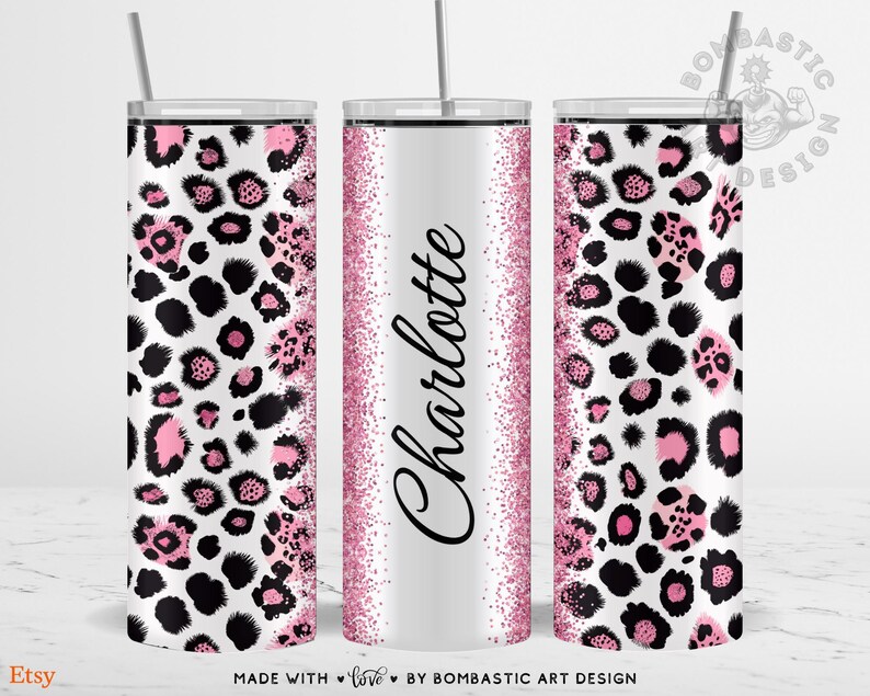 May include: Three stainless steel tumblers with lids and straws. The tumblers feature a white background with a pink and black leopard print design. The center tumbler has the name "Charlotte" in black script with a pink glitter border.