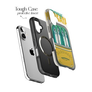 May include: A protective phone case with a sardine can design. The case is composed of three layers: a silver phone, a black protective insert, and a clear case with a sardine can graphic. The sardine can graphic is yellow and green with the word "Sardines".