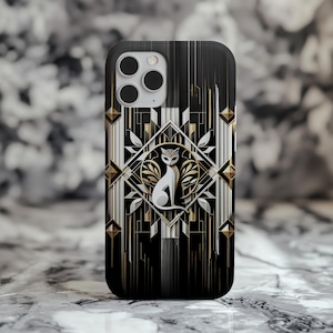 May include: A black and gold phone case with an Art Deco design. The case features a white cat silhouette in a diamond-shaped frame, surrounded by geometric patterns and gold accents. The case has a glossy finish.
