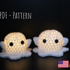 May include: Two white crocheted octopus night lights with black eyes. The text "PDF - PATTERN" is at the top of the image.