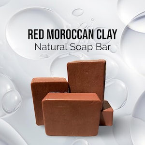 May include: Four bars of red Moroccan clay soap. The soap bars are stacked on top of each other. The soap is a natural product and is made with red Moroccan clay.
