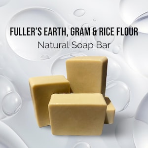 May include: Three bars of natural soap made with fuller's earth, gram & rice flour. The soap bars are a light beige color and are stacked on top of each other. The soap bars are on a white background with a few water droplets.