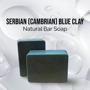 May include: Two bars of natural soap made with Serbian (Cambrian) blue clay. The soap is dark gray with a light blue stripe around the top.