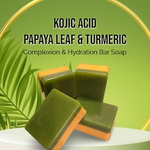 May include: Four bars of green and orange soap with the text "KOJIC ACID PAPAYA LEAF & TURMERIC Complexion & Hydration Bar Soap" on a green background.