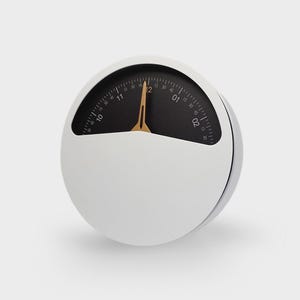 May include: A white circular timer with a black face and gold needle. The timer has markings for minutes and seconds. The timer is labeled "AN-030".