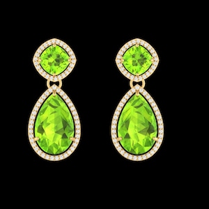 Puede incluir: Un par de pendientes colgantes de oro con una piedra preciosa de color verde lima en talla cojín en la parte superior y una piedra más grande en forma de pera en la parte inferior, rodeadas por un halo de pequeños diamantes blancos en oro amarillo.