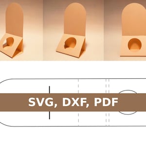 Könnte beinhalten: Eine druckbare Vorlage für einen Karton-Präsentationsständer. Die Vorlage ist gefaltet zu einem Ständer mit einem runden Ausschnitt dargestellt. Der Text "SVG, DXF, PDF" ist auf einem braunen Balken gedruckt.