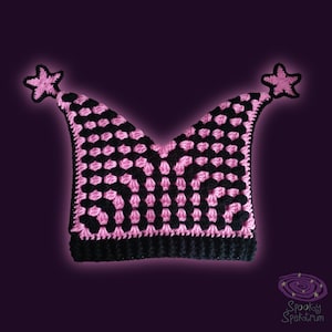 May include: A black and pink crocheted hat with star accents. The hat features a checkerboard pattern in pink and black, with a black brim and two star-shaped embellishments at the tips.