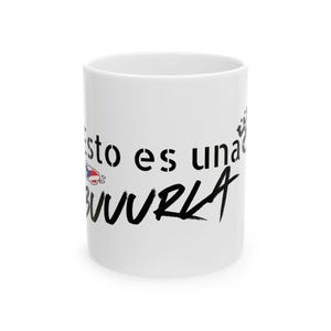 May include: White ceramic mug with black text that reads "Esto es una BUURRLA" in a mix of stencil and script fonts. A small graphic of a flag is on the left side of the mug.