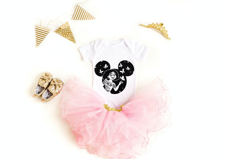 May include: A white baby onesie with a black Mickey Mouse silhouette featuring a cartoon character with butterflies. The onesie is paired with a pink tulle tutu and gold shoes.