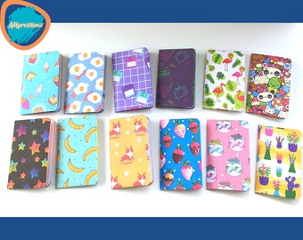 May include: Twelve small notebooks with different colorful patterns. The patterns include: ice cream cones, eggs, grid, TV, flamingos, pandas, stars, bananas, corgis, strawberries, cats, and plants.