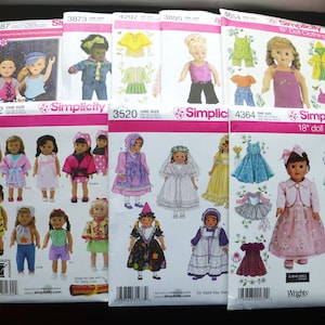 May include: A collection of eight Simplicity sewing patterns for 18-inch doll clothing, featuring various outfits including dresses, jackets, and skirts. Each white paper envelope displays illustrations of dolls wearing the garments with model numbers.