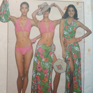May include: A vintage sewing pattern by Jiffy featuring bikini and beach cover-up designs. The pattern includes a pink halter bikini, a floral sarong, and a matching top. The cover-up and sarong have a green background with pink and orange floral patterns.