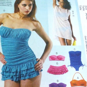 May include: McCall's pattern M6569 features a blue strapless swimsuit with a ruffled skirt. Additional swimwear options include a pink bikini top and skirt, a purple bikini, and an orange bikini top and bottom. The pattern also shows a white cover-up.