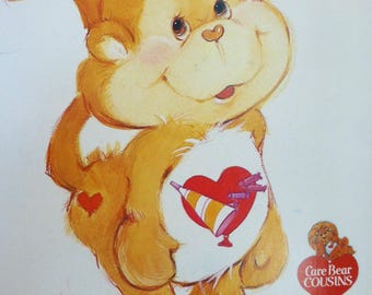 May include: Illustration of a cartoon monkey with a heart-shaped design on its chest. The monkey is light brown with a smiling face and a small heart on its rear. The image includes the text "Care Bear Cousins" and "Butterick".