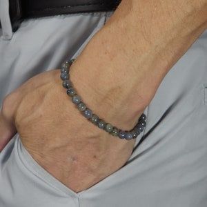 May include: A beaded bracelet with blue and green stones.