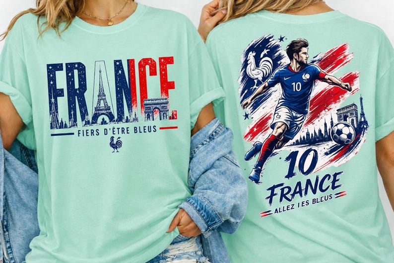 May include: A light green t-shirt with the word "FRANCE" in blue and red, featuring the Eiffel Tower and Arc de Triomphe. The back of the shirt has a soccer player and the text "10 FRANCE".