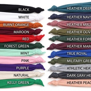 May include: A color chart displaying various fabric colors. Colors include black, white, burnt orange, maroon, red, forest green, mint, pink, purple, natural, and kelly green. Additional colors are heather deep teal, heather navy, heather mauve, heather olive, heather forest, heather maroon, true royal, military green, athletic heather, dark gray heather, and heather peach.