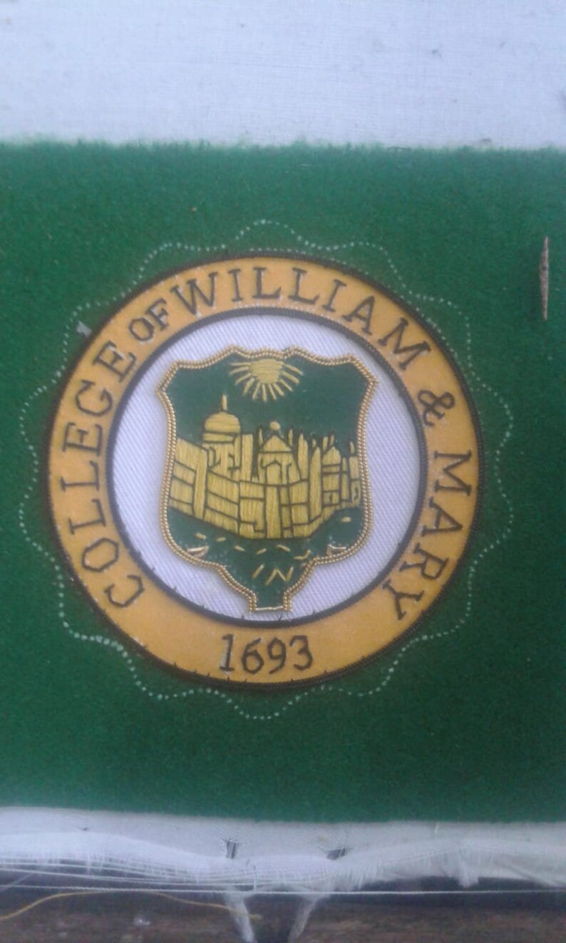 May include: A gold and green embroidered patch with the text "College of William & Mary" and the year "1693".
