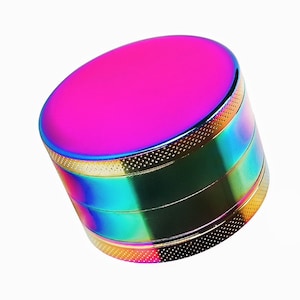 May include: A multi-colored metal grinder with a pink top and a rainbow finish.