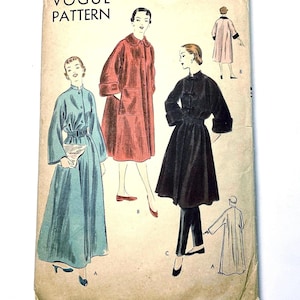 May include: A vintage Vogue Pattern envelope, number 7149, size medium, featuring illustrations of three coat styles. The designs include a long teal belted coat, a red coat with large pockets, and a black coat with a high collar and matching slim trousers.