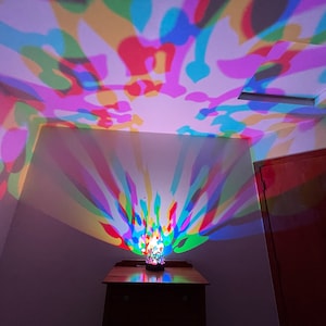 6 inch Decorative Cylinder Light rests on surface, and projects super bright color LED lighting designs!  Interchangeable metal art filters.