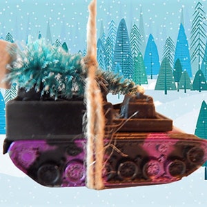 May include: A purple and black toy tank with a green and brown Christmas tree on top. The tank is in a snowy winter scene with blue and green trees in the background.