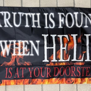 May include: Black flag with white text that reads "TRUTH IS FOUND WHEN HELL IS AT YOUR DOORSTEP." The bottom of the flag features a fiery orange and red flame design.