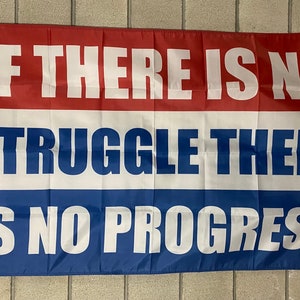 May include: A red, white and blue flag with the text "If there is no struggle there is no progress" printed in white.