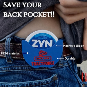 May include: A blue PETG material magnetic clip-on holder for a ZYN can, featuring the text SAVE YOUR BACK POCKET!!, TRACYFORGE, SINCE 2025, and a fish graphic. The holder is attached to a brown leather belt worn over blue denim jeans.