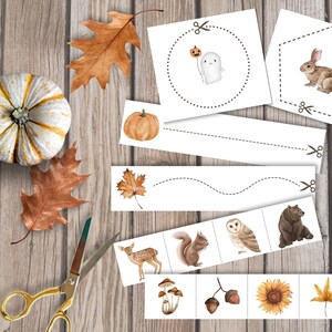 May include: A set of printable autumn-themed activity cards featuring images of a pumpkin, a ghost, a squirrel, a deer, an owl, a bear, mushrooms, acorns, a sunflower, and a leaf. The cards are designed for children to cut out and use for various activities, such as matching, sorting, and counting.