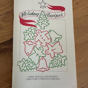 May include: A white booklet titled Holiday Recipes with a red and green line art illustration of a Christmas tree, gingerbread people, and bells. The text Home Service Department Iowa Public Service Company is printed at the bottom.