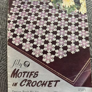 May include: A vintage instructional booklet titled Lily Motifs in Crochet Design Book No. 68. The cover features a photograph of a white and lavender floral crochet pattern spread over a dark surface, with yellow flowers visible at the top.