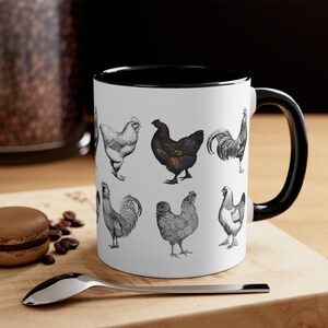 May include: White ceramic mug with a black rim and handle. The mug features a black and white illustration of various chickens and roosters.
