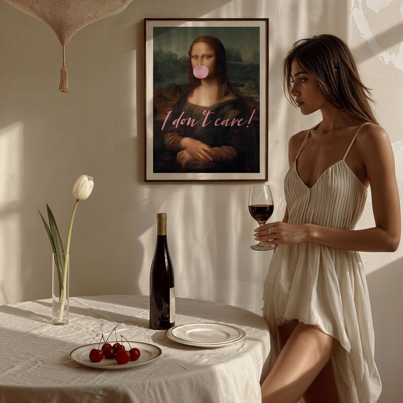 May include: A woman in a white dress holds a glass of red wine. A framed print of the Mona Lisa with the text "I don't care!" is hanging on the wall behind her.