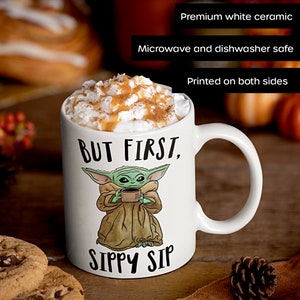 A white ceramic coffee mug featuring a cute illustration of Baby Yoda with the phrase "But First, Sippy Sip." A fun and nerdy mug, perfect for sci-fi fans, coffee lovers, and anyone who needs their caffeine fix before taking on the day.