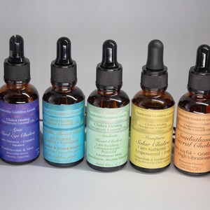 May include: Seven small brown glass bottles with droppers, each containing a different colored liquid. The bottles are labeled with the names of the seven chakras and their corresponding colors. The labels also include affirmations and essential oils used in each blend.
