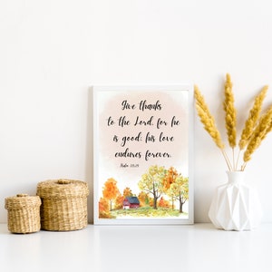 May include: A white framed print with a watercolor illustration of a red house in a fall forest. The print features the text "Give thanks to the Lord, for he is good: his love endures forever. Psalm 118:29".