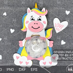 May include: A white unicorn with a yellow mane and tail holding a clear plastic container with white tissue paper inside. The unicorn is standing on a white cloud with pink hearts. The background is a grey fabric with white hearts. The text "LOVE YOU" is on a pink heart.