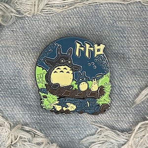 Main character and friends on a log spirit studio anime pin badge