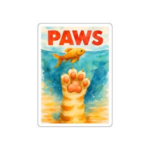 May include: A sticker featuring a watercolor illustration of a cat's paw reaching for a goldfish. The word "PAWS" is written in large, red letters above the water. The background is a mix of blue and yellow hues.