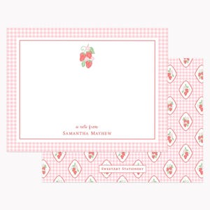 May include: A rectangular stationery card with a light pink gingham border and a central strawberry illustration. The text reads a note from SAMANTHA MAYHEW. Below, a matching envelope liner features a repeating pattern of strawberries in diamonds.