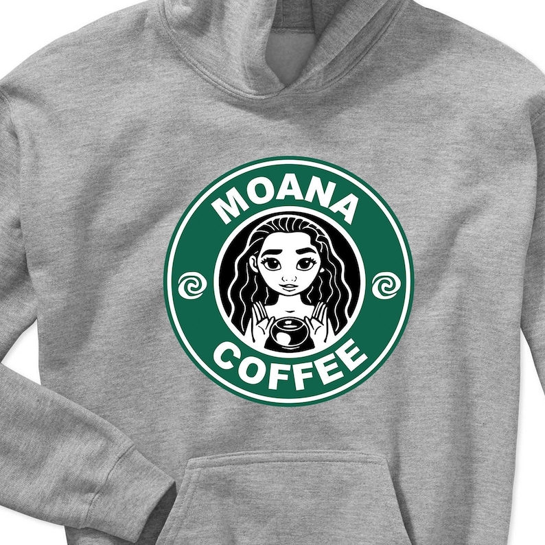 Puede incluir: Una sudadera gris con un logotipo circular verde que dice "Moana Coffee" con una imagen de dibujos animados de Moana dentro del c&iacute;rculo.