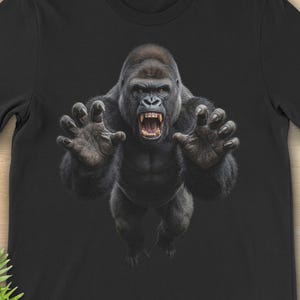 May include: Black t-shirt featuring a detailed illustration of a gorilla with an open mouth and outstretched hands. The shirt has the text "SINISTER DEXTER DESIGN" at the top left. The word "BLACK" is at the bottom center.