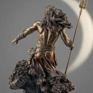 May include: Bronze statue of a male figure, seen from behind, holding a trident. The figure has long flowing hair and wears a crown and draped clothing. The statue is mounted on a base resembling a wave.